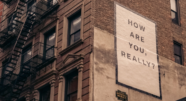 Quote painted on the side of a building reading: 